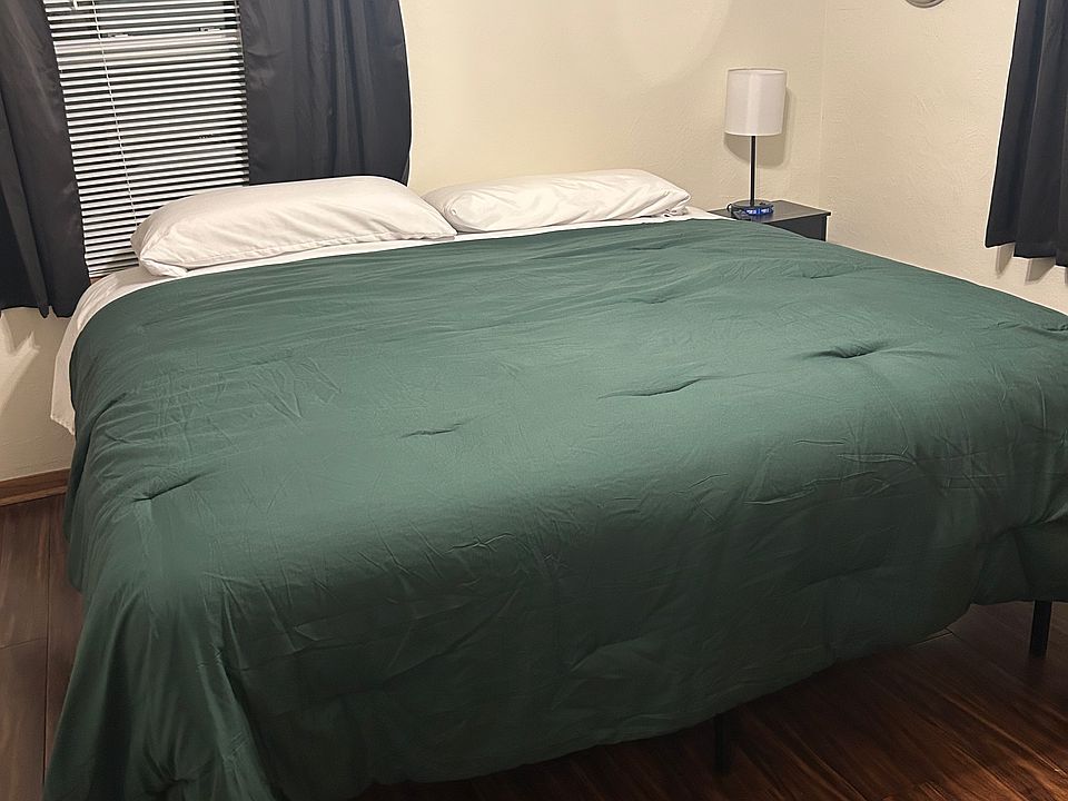 One of the 2 private locked bedrooms in the house with a king bed.