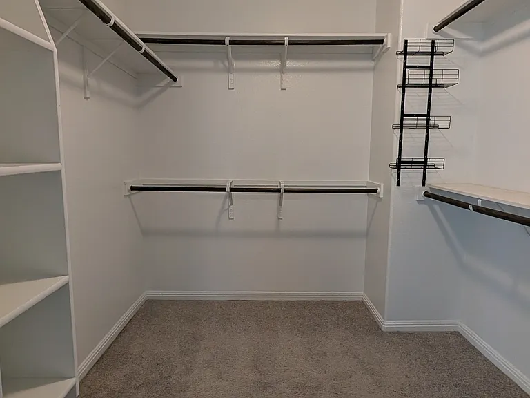 Walk-in closet in primary bedroom