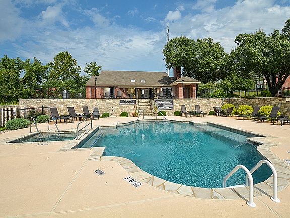 Outdoor Pool and Hot Tub Surrounded by Sundeck