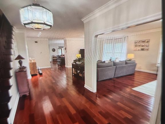 This view of the front foyer shows sight lines that go thru to the sunroom and backyard.