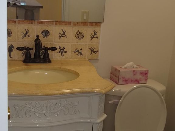 Beautiful bathroom with marble top sink and big double mirrored "bonus magnifying 10x mirror inside" medicine cabinet__