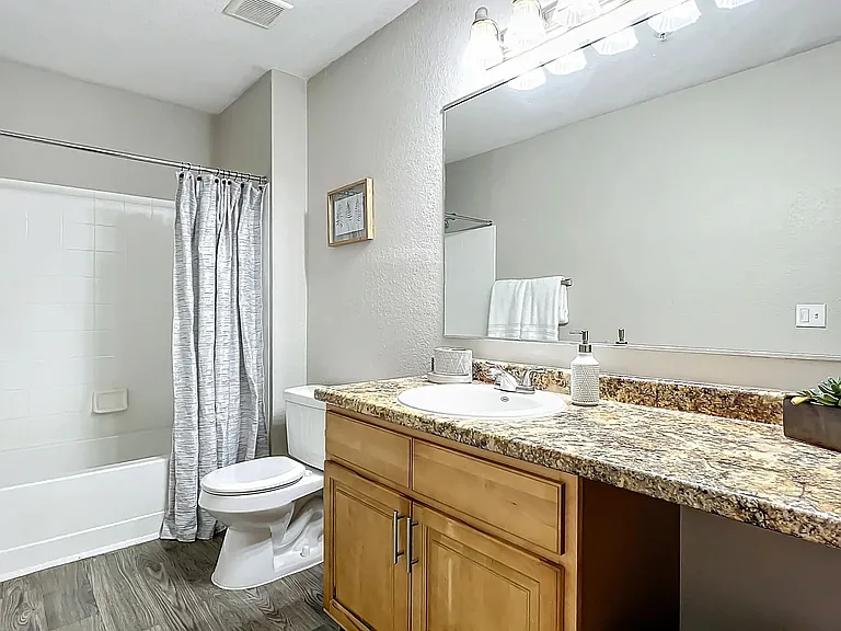 Enjoy the elegance and functionality of our modern bathrooms, featuring granite-style countertops, ample storage, and a sleek design.