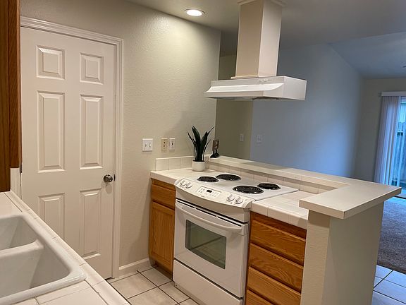 Kitchen open to family room and view through slider.