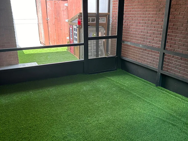 COVERED PORCH AREA,
FACING EXTERIOR PATIO AREA WITH KIDS PLAYHOUSE AND A STORAGE AREA.