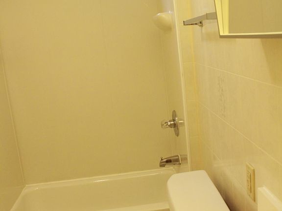 Bathroom with apartment size tub