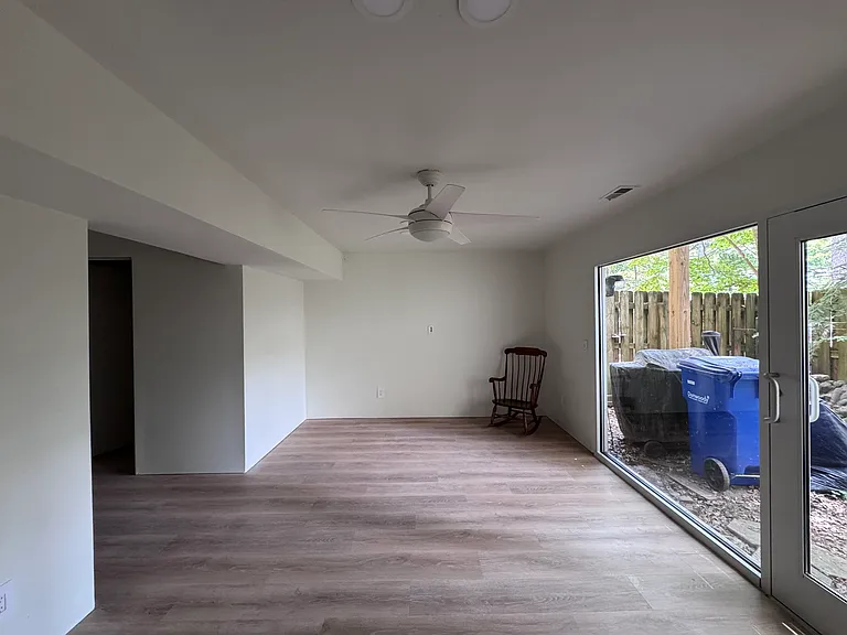 Finished basement-level room for an office or home theater. This space opens onto the back patio/garden.