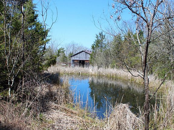 Barn and pond along the devil s backbone ridgetop in the center of the property