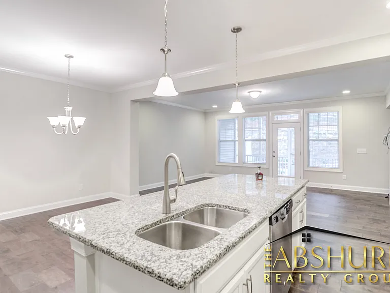 Luxurious open concept kitchen w/ oversized island, granite countertops, SS appliances, 2 wall ovens