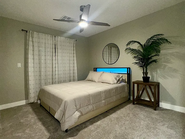 First-Floor Bedroom with Sliding Doors to Backyard and Direct Bathroom Access
