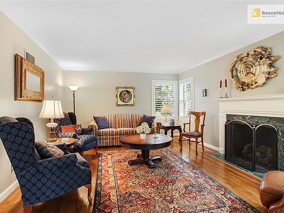 The Living Room offers views of the front and back yards along with a wonderful gas fireplace.  Gleaming hardwood floors, fresh paint and custom plantation shutters are not to be missed.