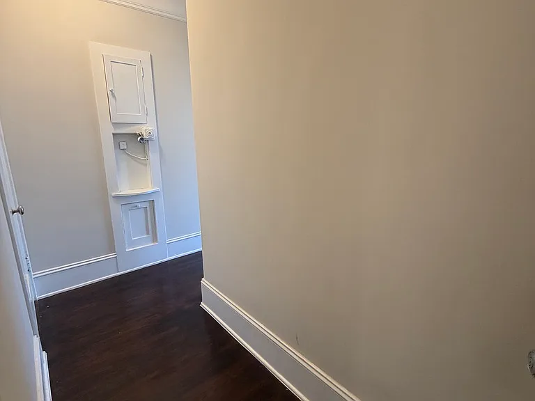 View through hallway from front door. Bathroom is at the end on the right.