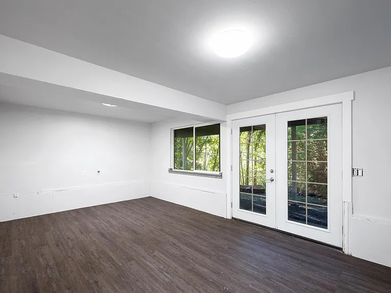 Lower level with french doors to patio can also be a bedroom also with laundry room & closet