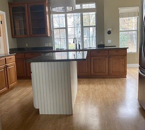 Large kitchen accommodates multiple cooks with french-door fridge, separate stove and double oven, and deep double sink. Friends and family feel at home and can move freely about the kitchen, nook, and living room