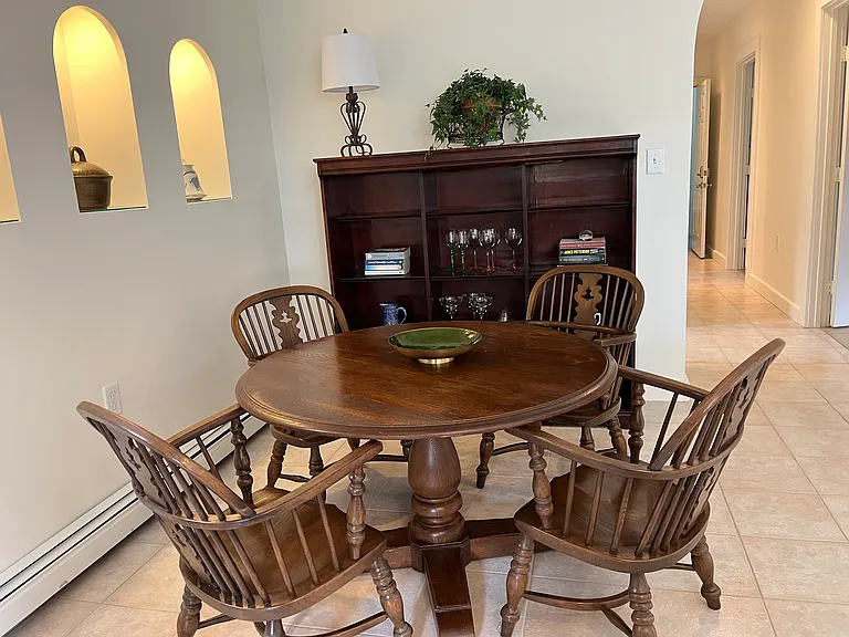 Casual table and chairs and storage shelves can be used for meals or an optional work space.