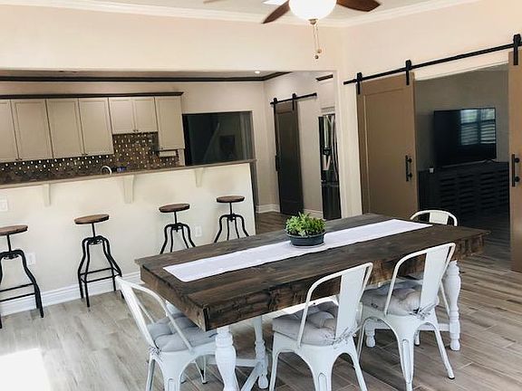 Bright dining room located right off the kitchen and under skylights. Barn doors lead into the family room.