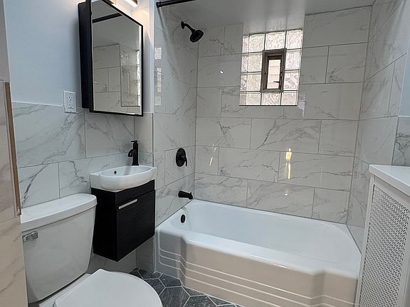 Updated bathroom, new vanity, mirror, lighting, etc