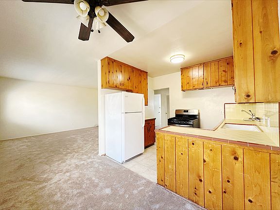 Vintage wooden cabinetry compliments the retro Crown Point/Pacific Beach tiled countertops!