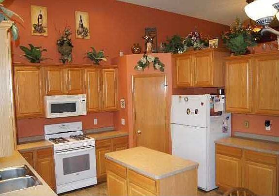 The kitchen offers oak cabinets, center island and a deep pantry