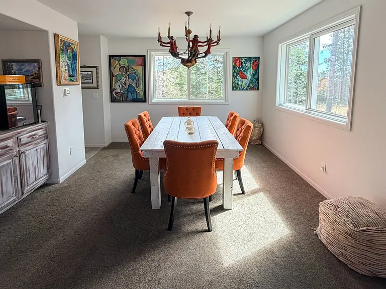 Built in cabinets painted by artist, dining area with beautiful views. Different chandelier will be installed