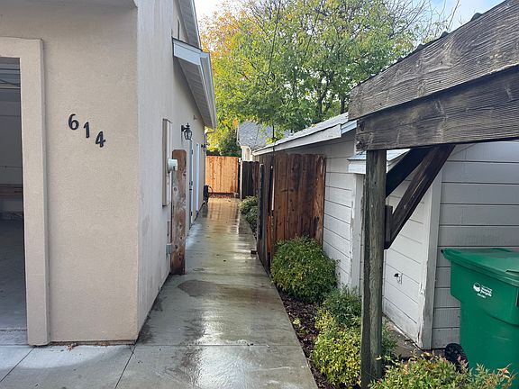 Peek at two car garage and pathway to front door