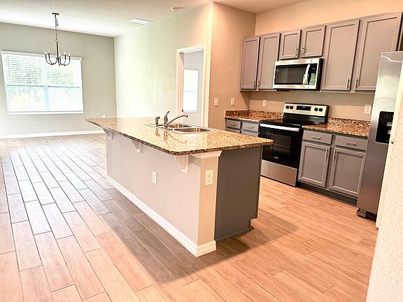 Open kitchen with granite countertops and convenient pantry ensures ample storage space for your culinary essentials.