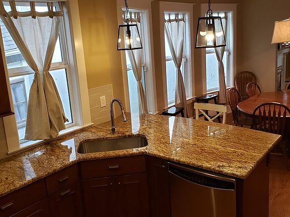 Open top-floor kitchen layout overlooking the dining room.