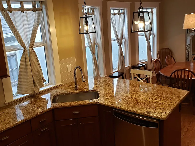 Open top-floor kitchen layout overlooking the dining room.