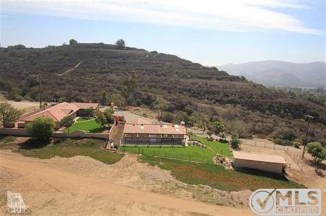 Property overview, from left to right, main house, guest house, Utility building with horse coral.