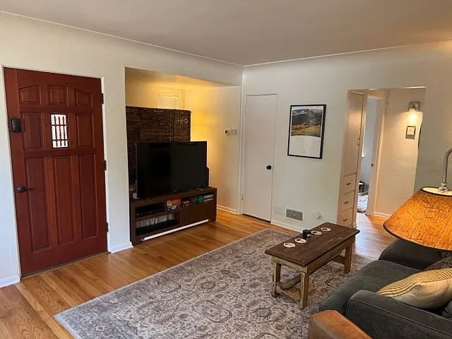 Front entryway, entertainment area, coat closet, and living room.