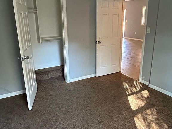 Back bedroom showing closet. Carpet floor