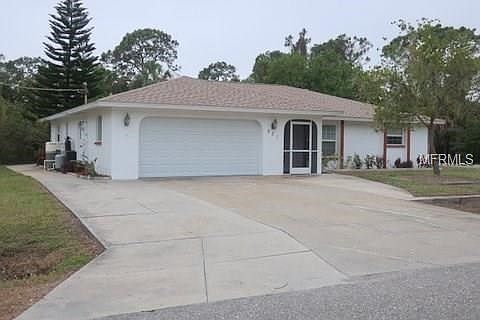 View of home with extra cement pad