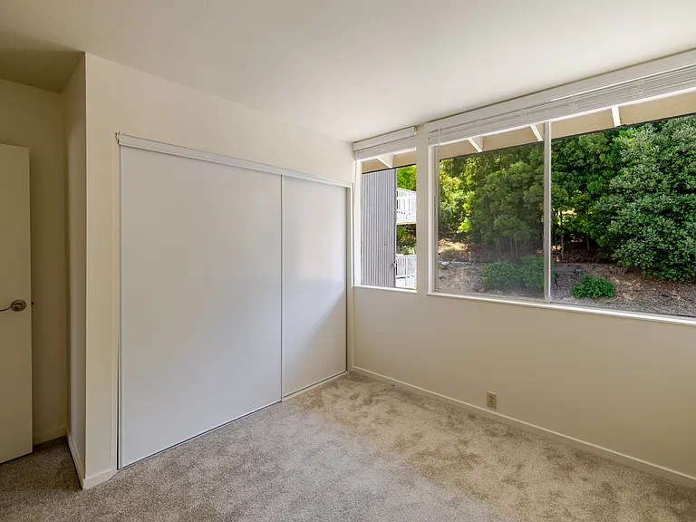 Enjoy a peaceful retreat in Bedroom A with calming views of the surrounding greenery.