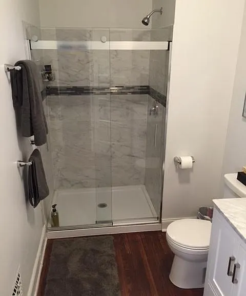 tiled custom shower with Kohler glass doors