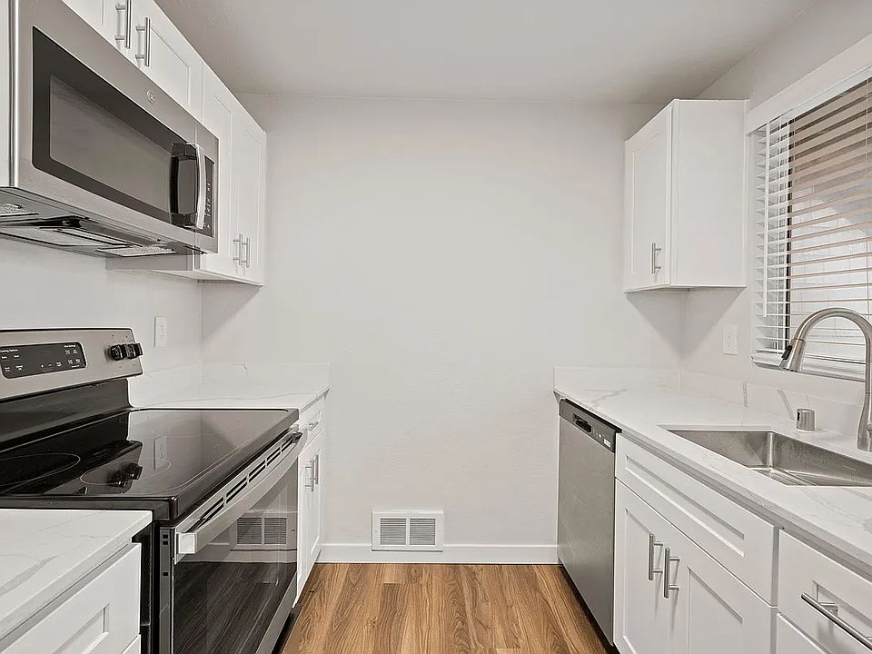 Kitchen with updated quartz countertops and stainless steel appliances
