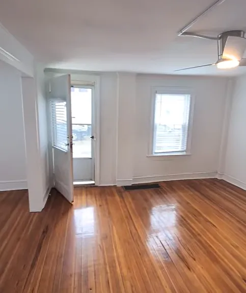 Dining room and front door viewed from kitchen doorway.