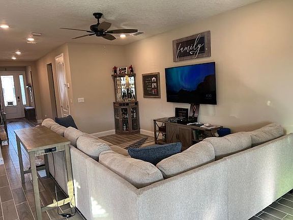 Plenty of ceiling lights and a new ceiling fan added by owners.