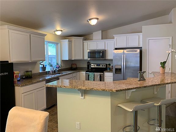 Newer kitchen with granite counter tops and stainless steel appliances.  Pantry to the right of picture.