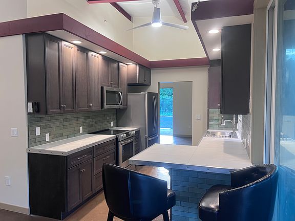 Standing in the large living room looking through the kitchen into the dining room and front door