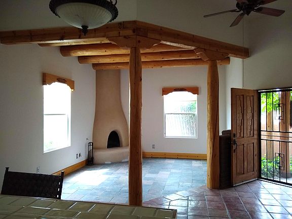 Welcome! LR ; enjoy toasty winter evenings around the gas/wood fireplace. vigas, slate tile. (from kitchen)