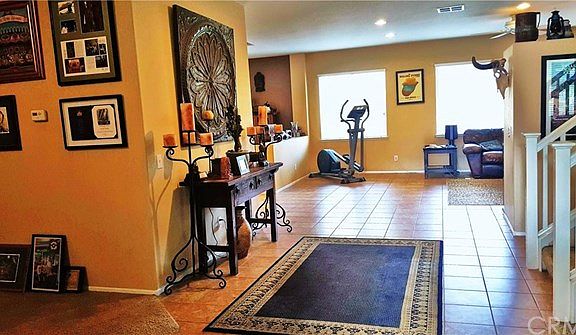 Warm and welcoming entry with custom colors and tile flooring.