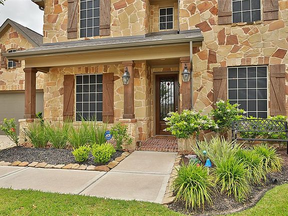 Enjoy the front covered porch as spring blooms.