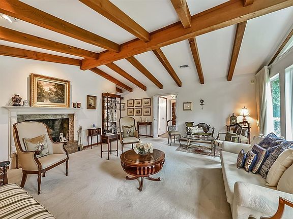 Another perspective of the formal living room with view toward the fireplace and foyer.
