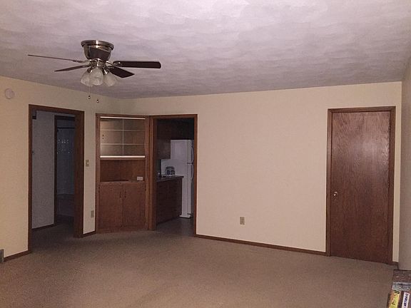 mainfloor living room w/built -in hutch and closet for storage/coats, new ceiling fan