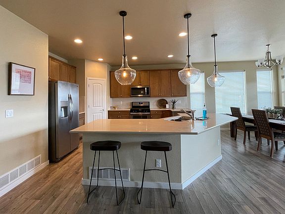 Kitchen with pendant lighting & laminate flooring