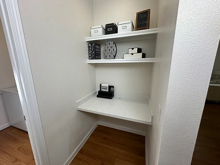 Cozy home office nook with built-in shelves, stylish storage boxes, and a quartz countertop, perfect for maximizing functionality in a compact space. Cozy home office nook with built-in shelves, stylish storage boxes, and a quartz countertop, perfect for