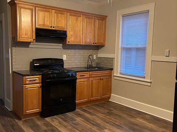 Another view of the eat-in-kitchen facing towards front of the property, there are 2 large kitchen windows looking down onto the side of property where the driveway is.