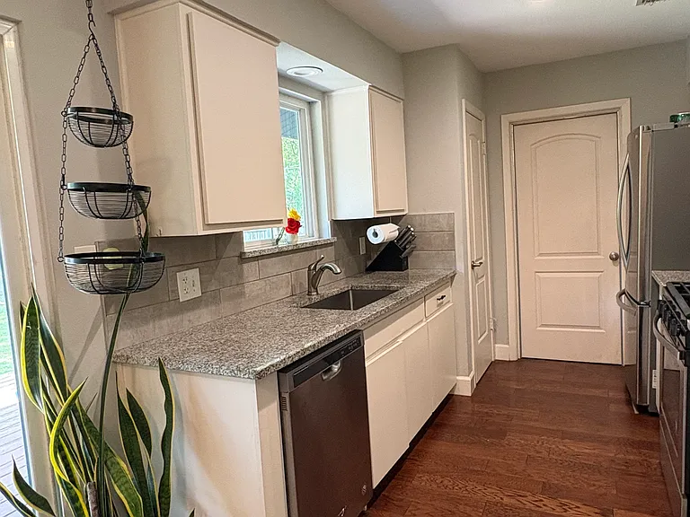 Galley style kitchen with a door to the garage. Lots of natural light!