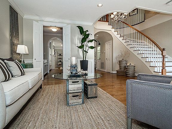 Another view in the formal living room but showing the open flow of the home and the curve of the st
