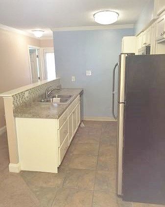 Kitchen has appliances furnished.