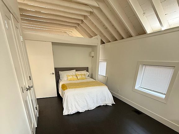 Bedroom 1 off of Living Room. Full Bed with dedicated full bathroom thru the french doors on left.
